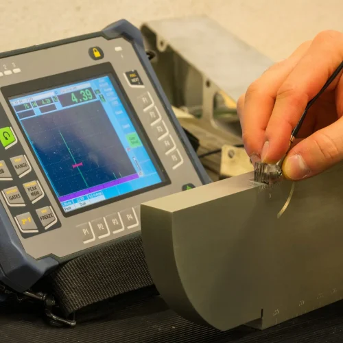 Ultrasonic Testing Equipment Calibration in Industrial NDT Lab: Professional Inspector Setting Up UT Device for Non-Destructive Testing